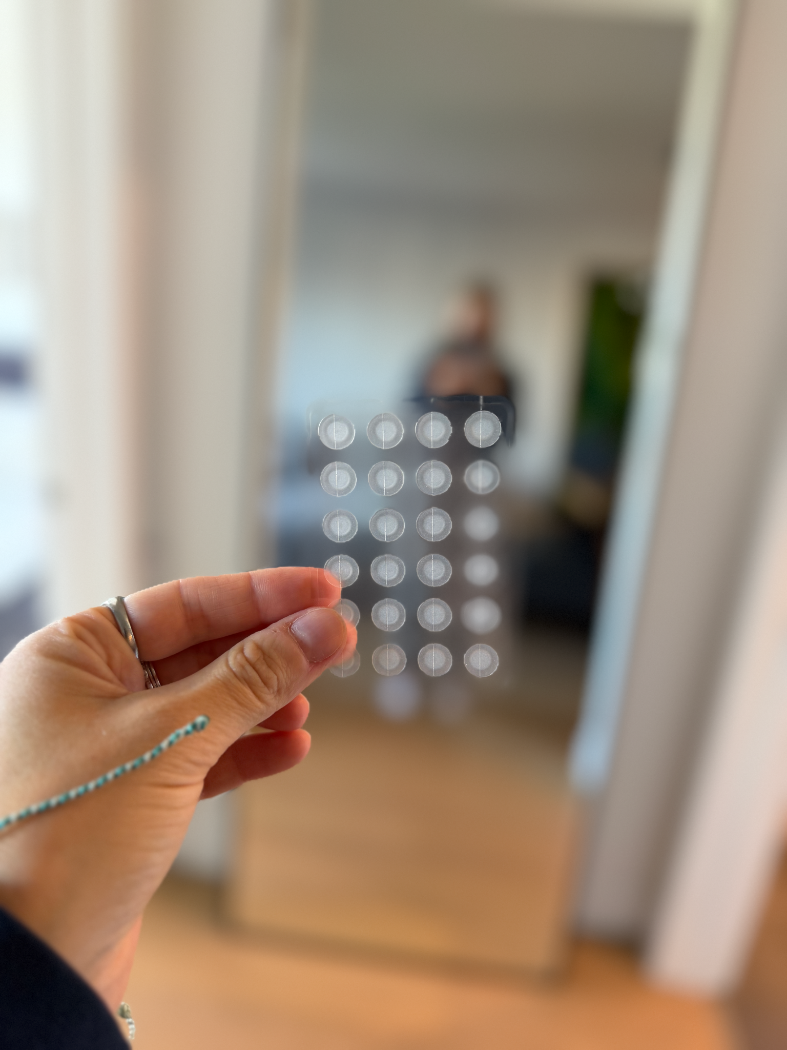 DotPop Labs patch prototype held in front of a mirror